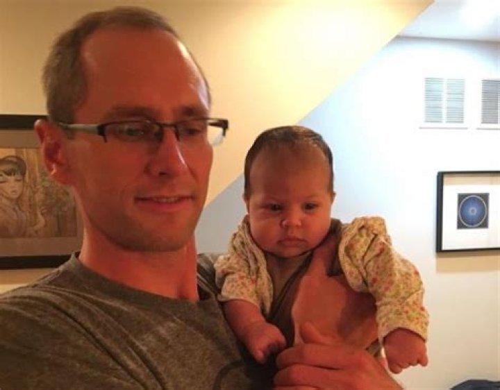 Charles Morris holding Mike's daughter